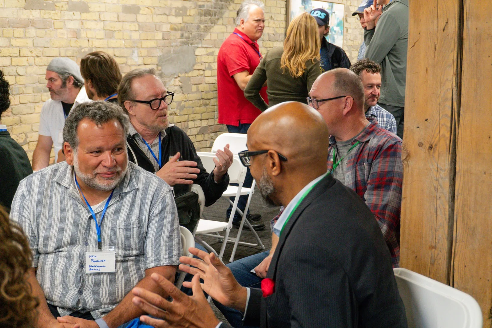 Opening-day attendees talking between sessions inside Origin House