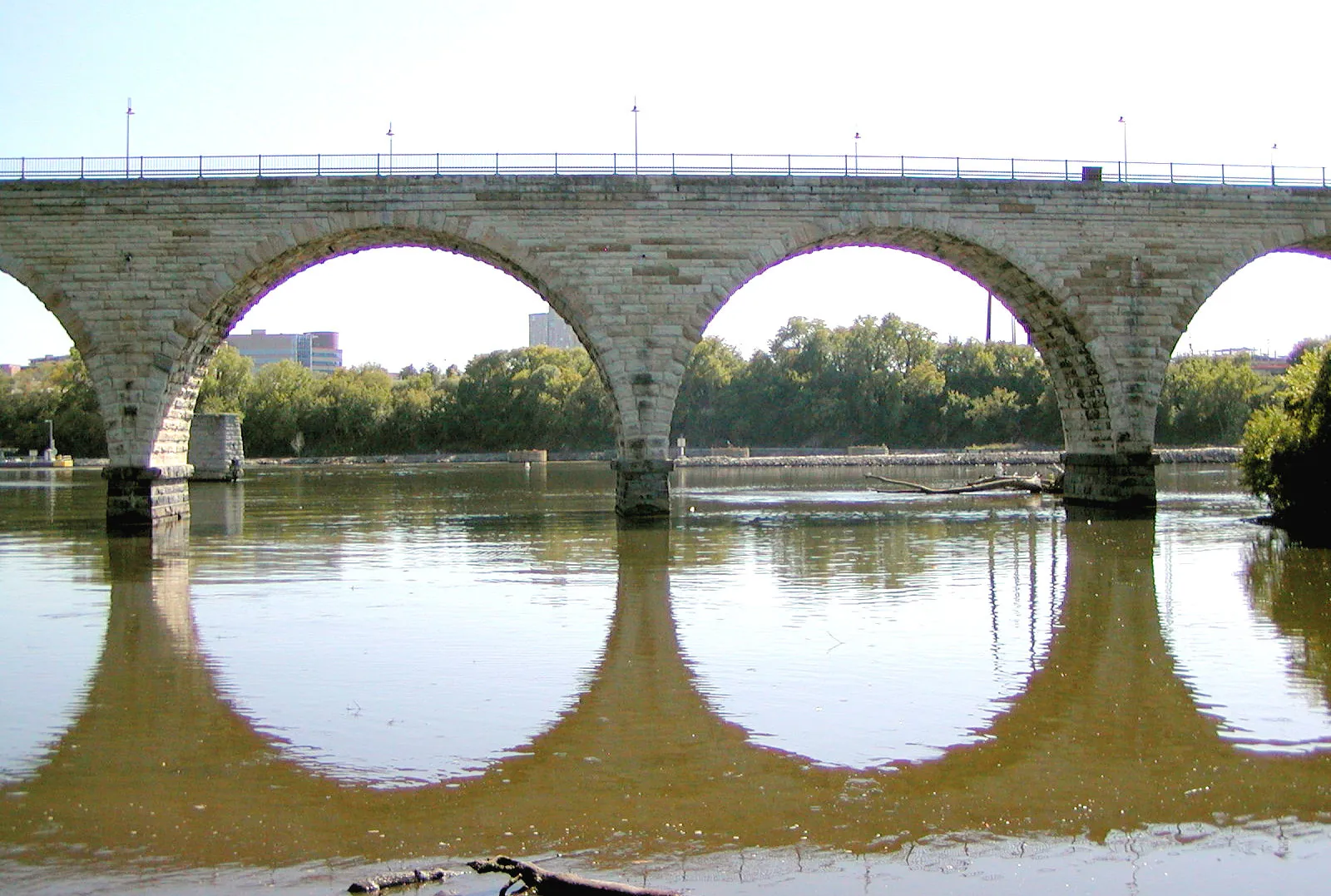 The Stone Arch Bridge in Minneapolis, limestone arches reflected on the Mississippi